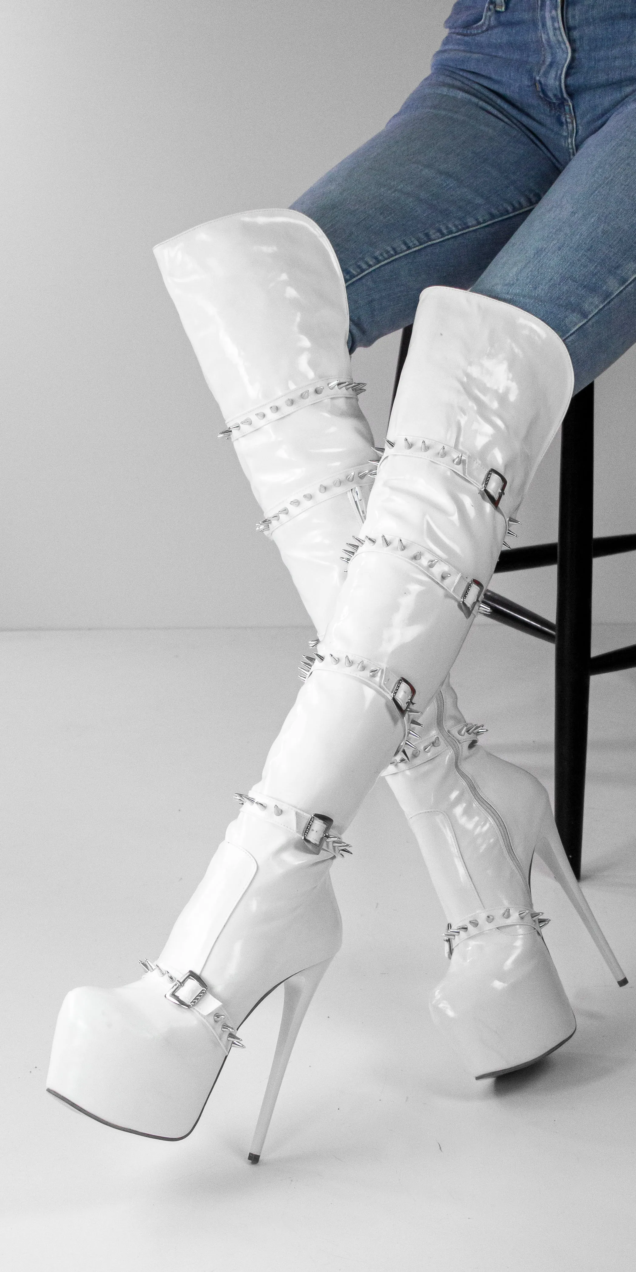 White spiked knee high boots.