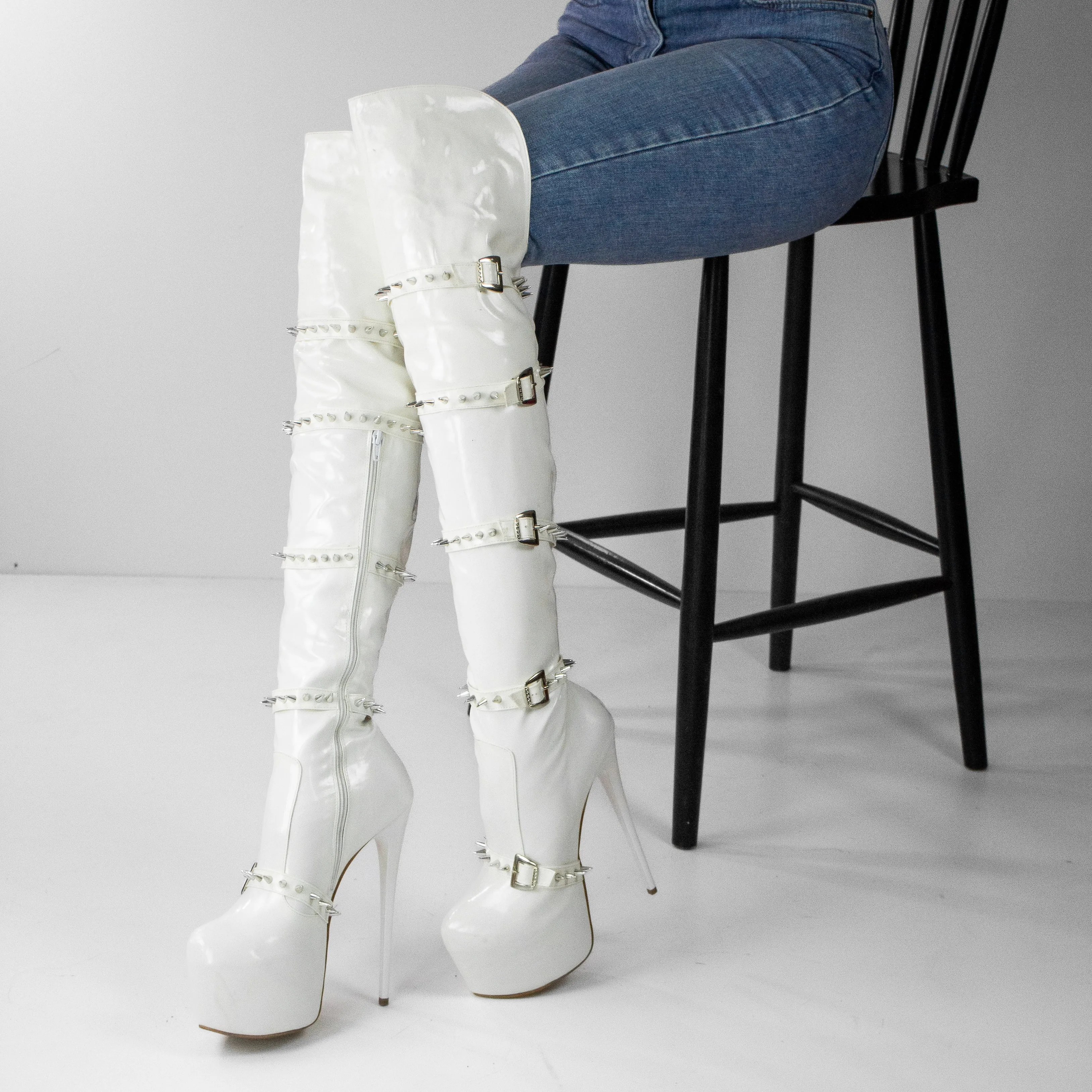 White spiked knee high boots.